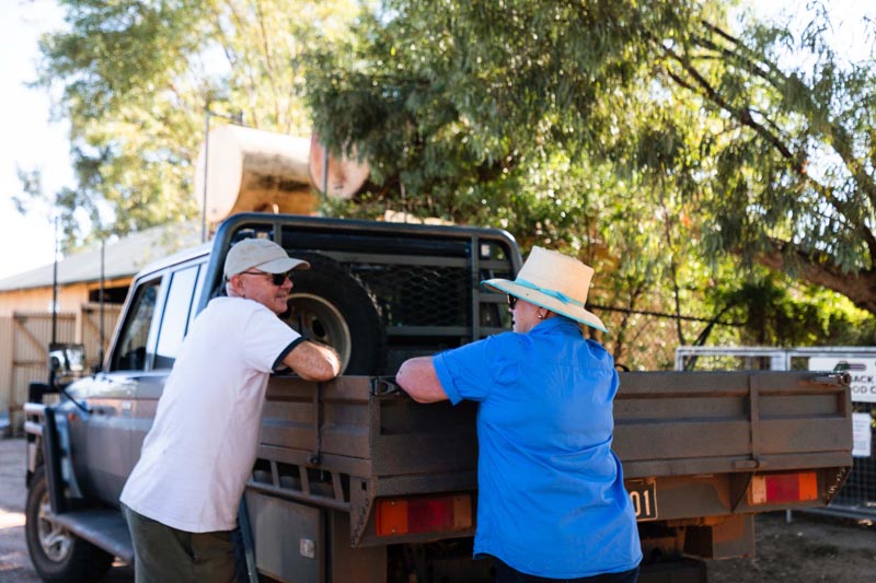 Two people chatting beside a utility vehicle at Trilby Station