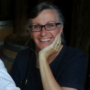 Cathy smiling with her chin resting on her hand