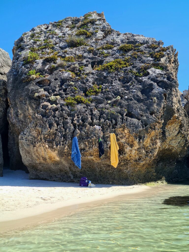 Clear coastal water beneath weathered limestone cliffs