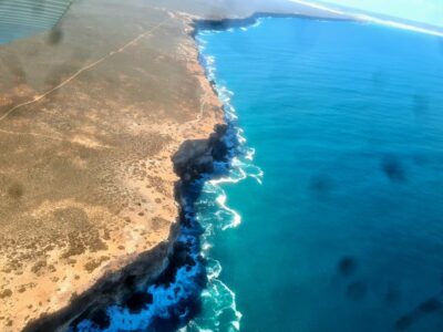 Aerial view of the Eyre Peninsula's ochre cliffs and vivid blue Southern Ocean